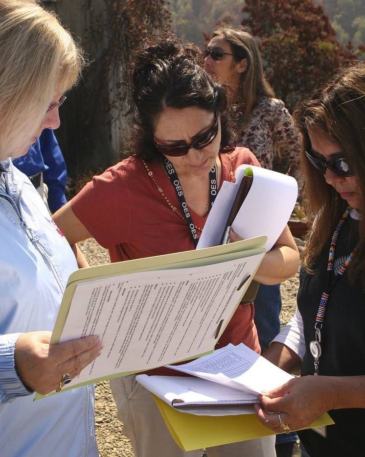 Damage assessors comparing notes in the field