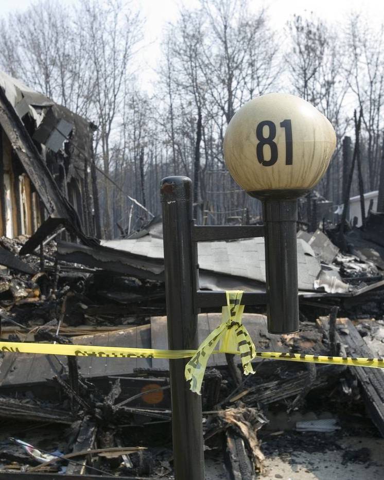 Burned-out home behind caution tape