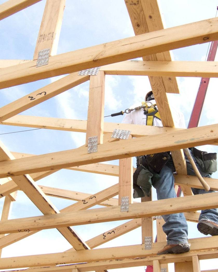 Framer working on the roof trusses of a new house