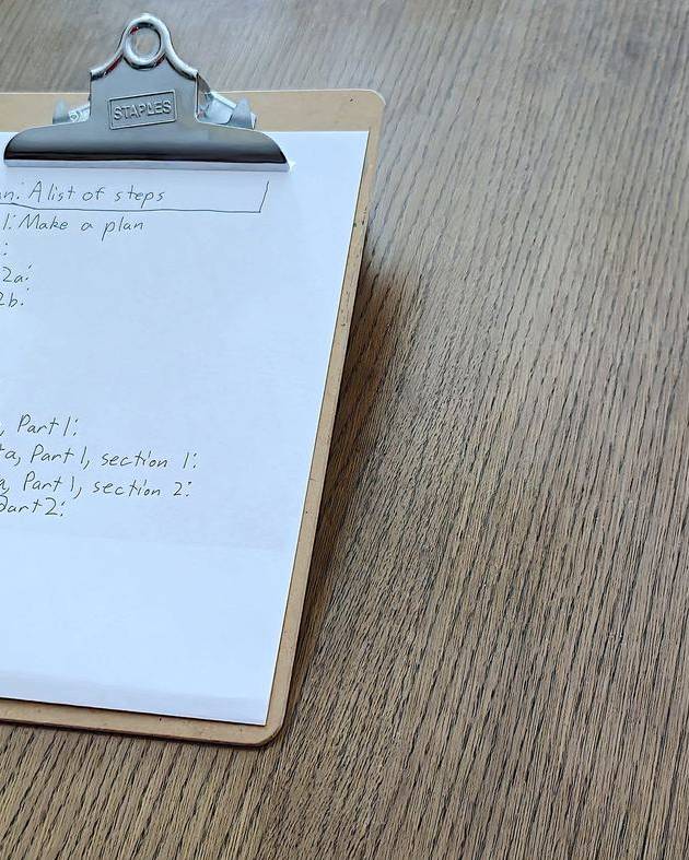 Clipboard with a handwritten step-by-step plan