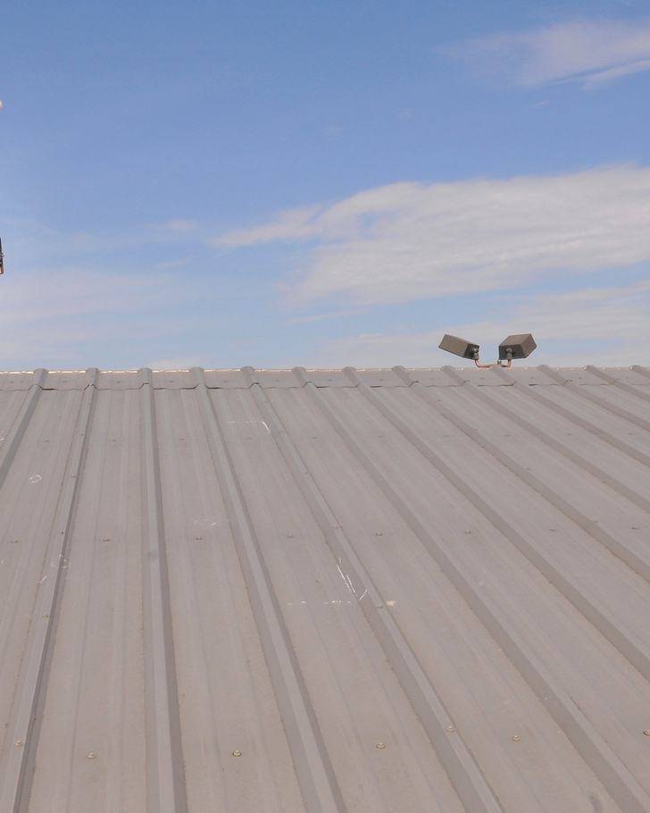 Inspector examining a hail-damaged roof