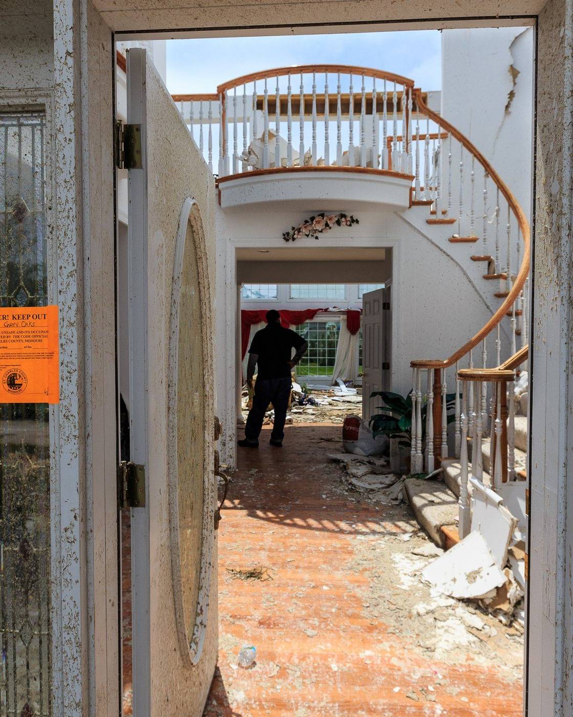 View through the front door of a home wrecked by a tornado