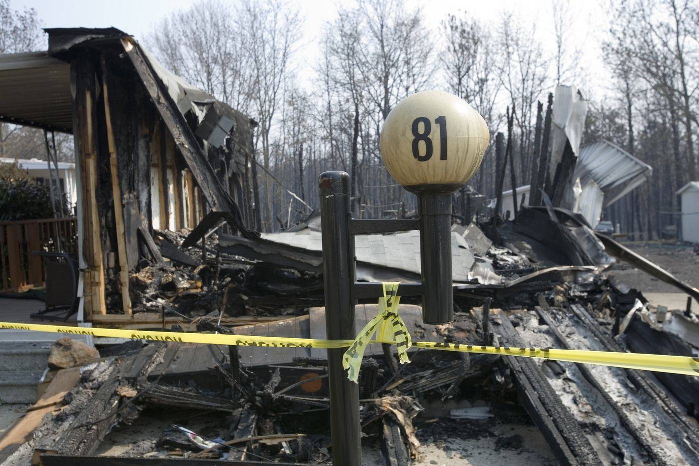 Burned-out home behind caution tape