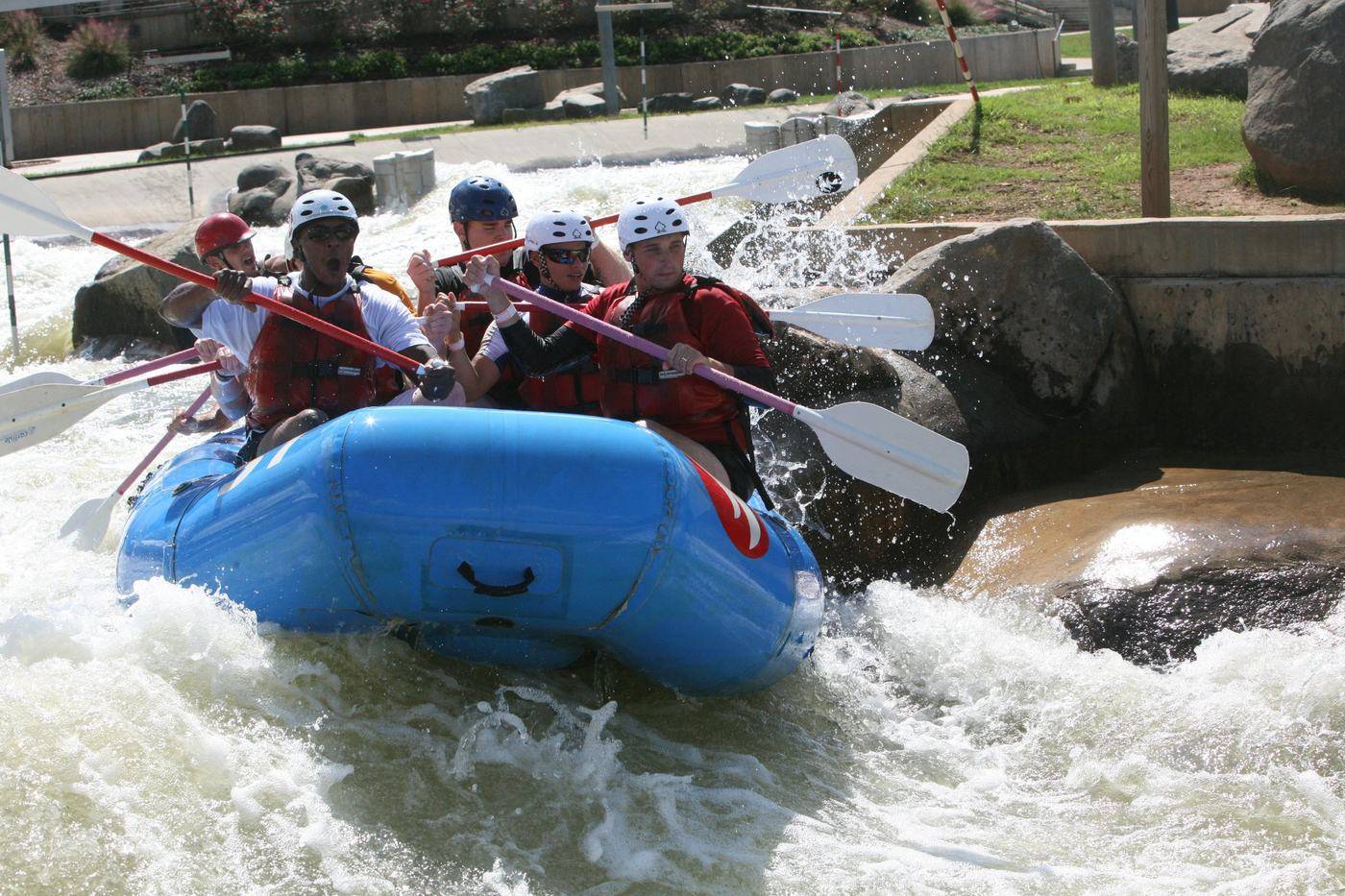Raft heading down a whitewater channel at the U.S. National Whitewater Center