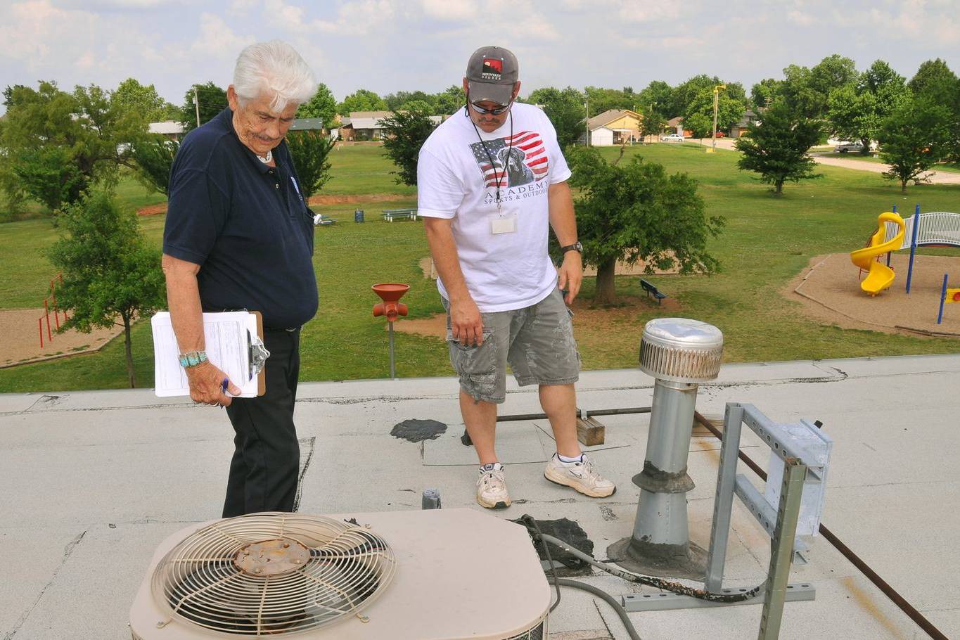 Inspectors documenting damage on a roof