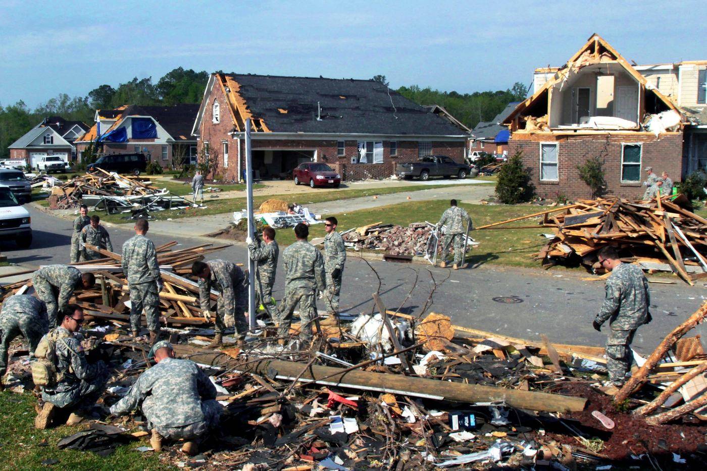 Cleanup crews in a tornado-damaged neighborhood in Fayetteville, North Carolina